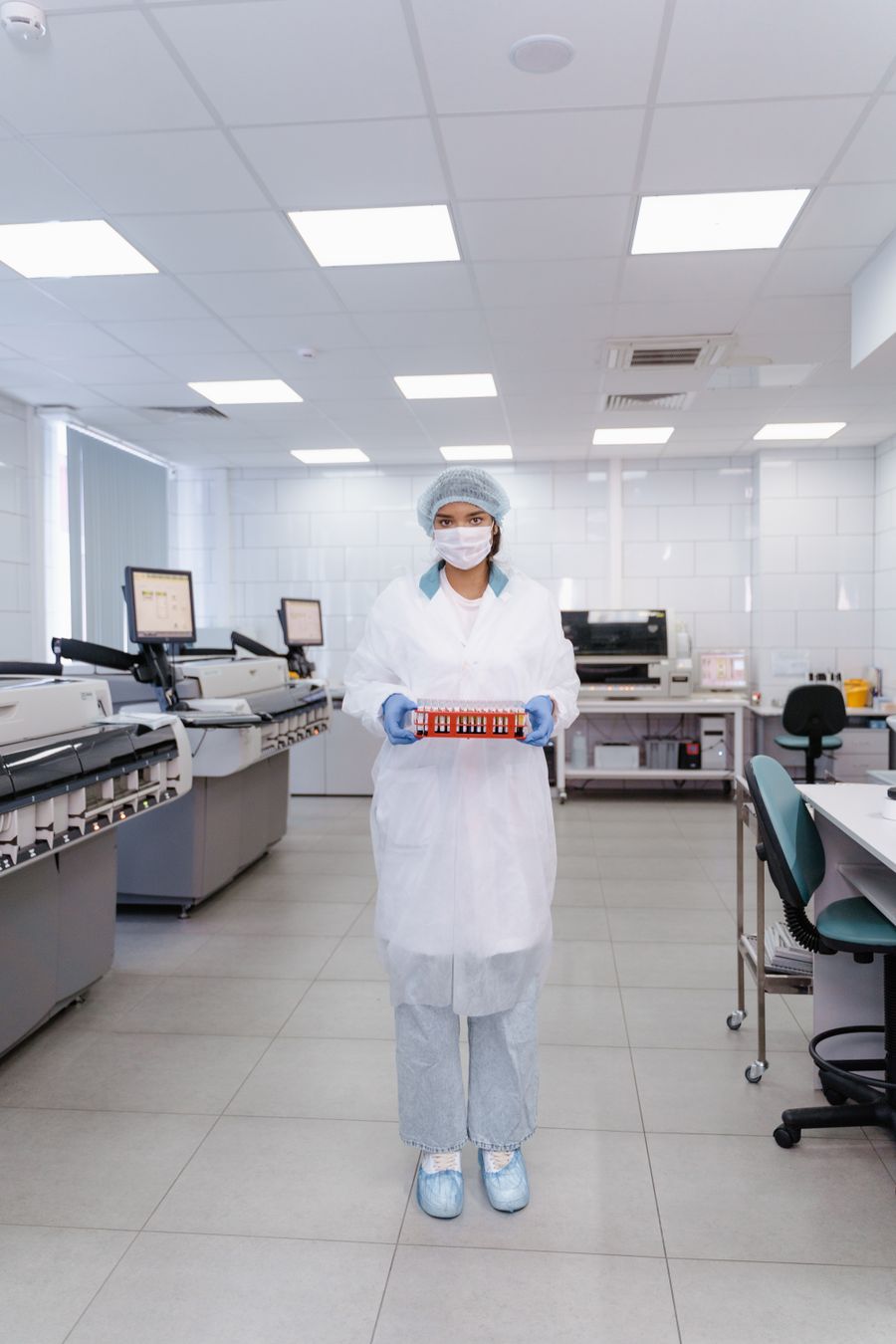 Laboratory technician holding blood sample vials